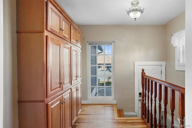 doorway to outside with light wood-type flooring