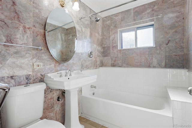 bathroom featuring toilet, tiled shower / bath combo, tile walls, and ornamental molding