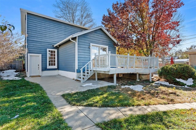 back of house with a wooden deck