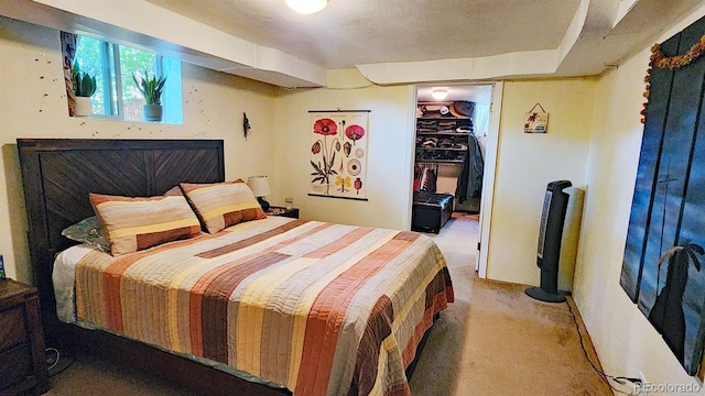 carpeted bedroom with a spacious closet and a closet