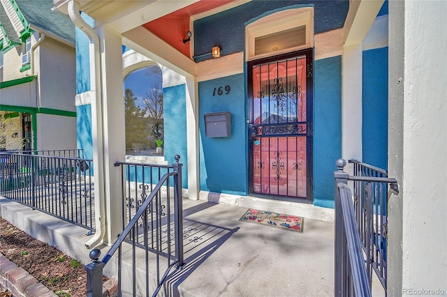 property entrance with stucco siding