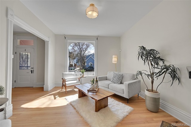 living area with baseboards and light wood-type flooring