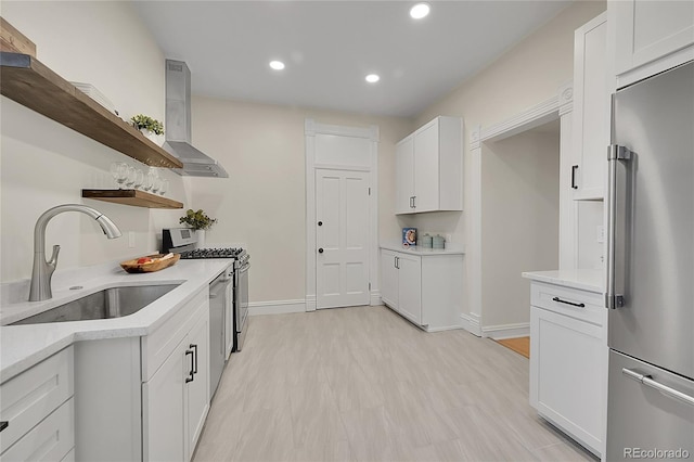 kitchen featuring open shelves, a sink, stainless steel appliances, white cabinets, and wall chimney range hood