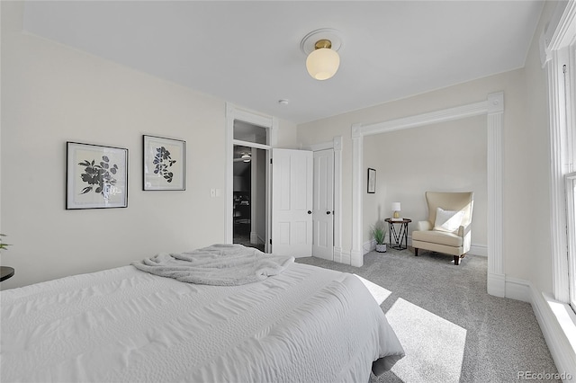 carpeted bedroom featuring baseboards