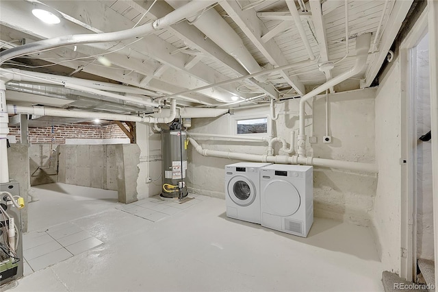 below grade area featuring gas water heater and separate washer and dryer