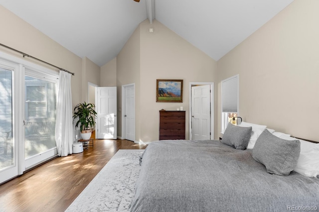 bedroom with high vaulted ceiling, access to outside, beam ceiling, and wood finished floors