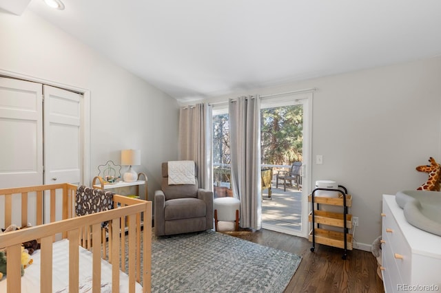 bedroom with dark wood finished floors, a closet, vaulted ceiling, access to outside, and baseboards