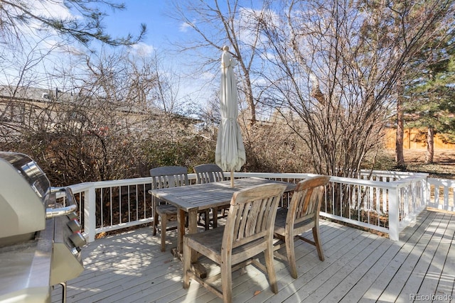 wooden terrace with outdoor dining area