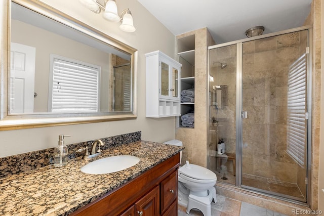 bathroom with toilet, a shower stall, and vanity