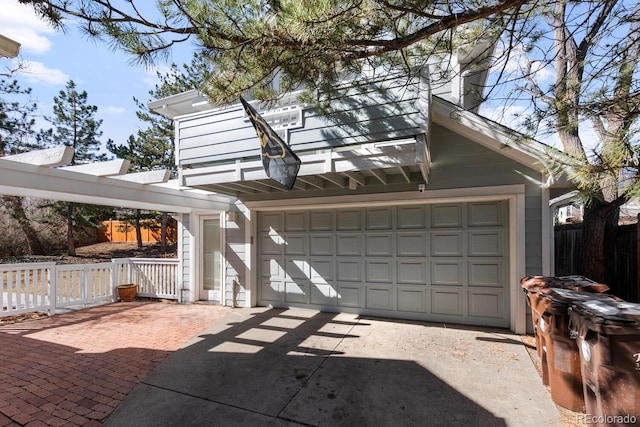 detached garage featuring fence