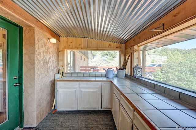 24700 US Highway 285, Buena Vista, CO 81211 - kitchen with tile counters, white cabinetry, and dark colored carpet