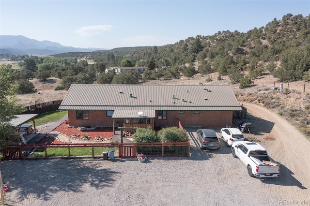 24700 US Highway 285, Buena Vista, CO 81211 - view of front facade with a fenced front yard, a metal roof, a mountain view, and a forest view
