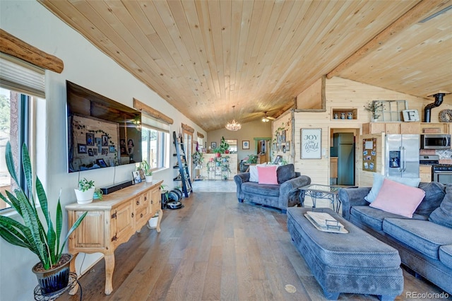24700 US Highway 285, Buena Vista, CO 81211 - living room featuring vaulted ceiling, hardwood / wood-style floors, wood ceiling, wooden walls, and a chandelier
