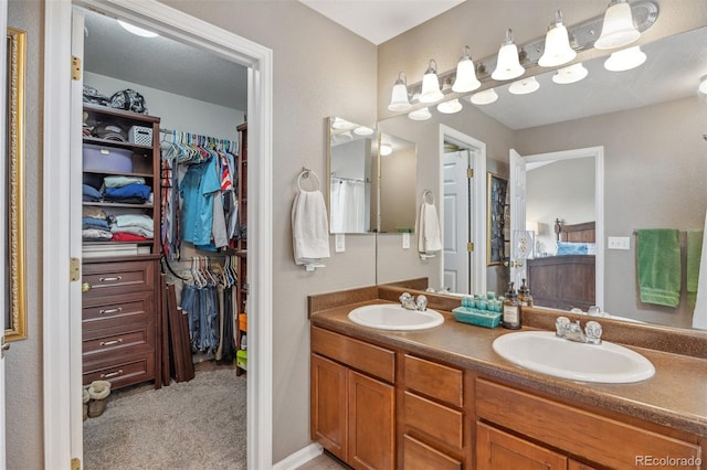 full bathroom featuring double vanity and a spacious closet