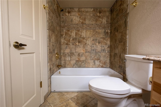 bathroom featuring toilet, a textured wall, and shower / tub combination