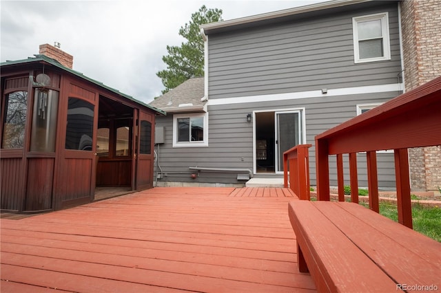 wooden deck with a sunroom