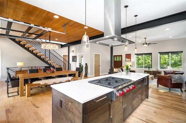 2669 N Cherry St, Denver, CO 80207 - kitchen featuring open floor plan, stainless steel gas cooktop, island range hood, light wood-style flooring, and recessed lighting