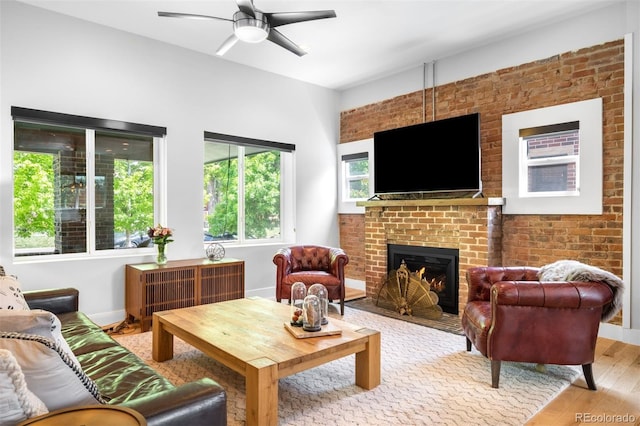 2669 N Cherry St, Denver, CO 80207 - living area with light wood-style floors, ceiling fan, a brick fireplace, and baseboards