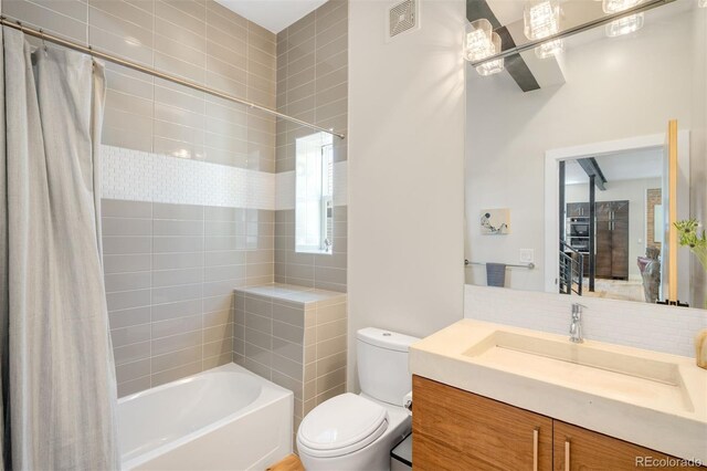 2669 N Cherry St, Denver, CO 80207 - bathroom featuring shower / tub combo with curtain, toilet, vanity, and decorative backsplash