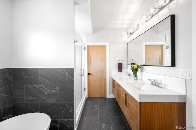 2669 N Cherry St, Denver, CO 80207 - full bath with marble finish flooring, tile walls, double vanity, a soaking tub, and a shower stall