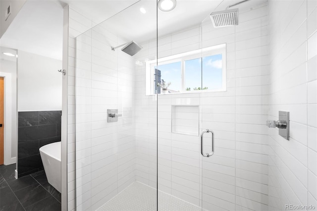 2669 N Cherry St, Denver, CO 80207 - bathroom featuring a shower stall, a freestanding bath, tile walls, recessed lighting, and tile patterned flooring