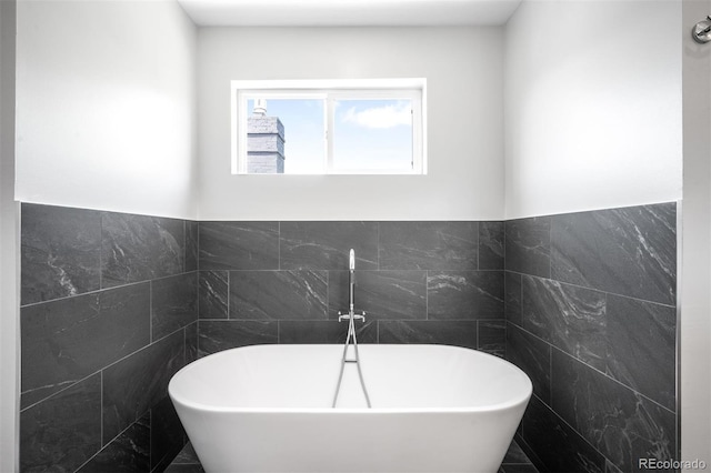 2669 N Cherry St, Denver, CO 80207 - full bathroom with tile walls, a soaking tub, and wainscoting