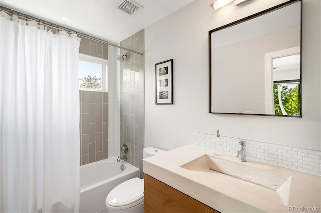 2669 N Cherry St, Denver, CO 80207 - full bathroom featuring toilet, tasteful backsplash, plenty of natural light, and shower / bath combo with shower curtain