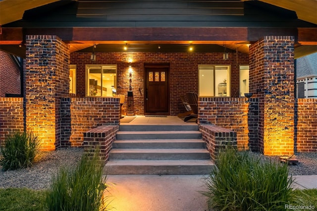 2669 N Cherry St, Denver, CO 80207 - view of exterior entry with a porch and brick siding