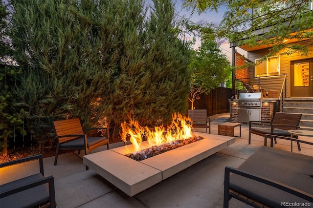 2669 N Cherry St, Denver, CO 80207 - patio terrace at dusk with an outdoor fire pit, a patio, and grilling area