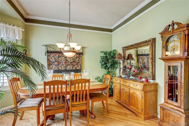 10292 Nickolas Ave, Highlands Ranch, CO 80130 - dining space featuring a chandelier, light wood-style floors, and crown molding