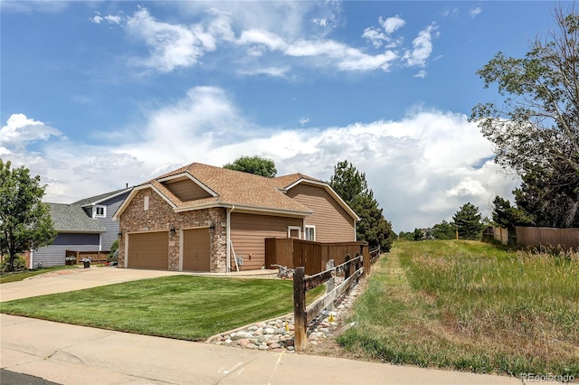 10292 Nickolas Ave, Highlands Ranch, CO 80130 - view of front of house featuring stone siding, driveway, an attached garage, and roof with shingles