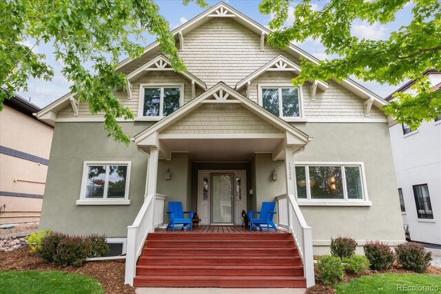 1526 S Gaylord St, Denver, CO 80210 - view of front facade featuring stucco siding and a porch