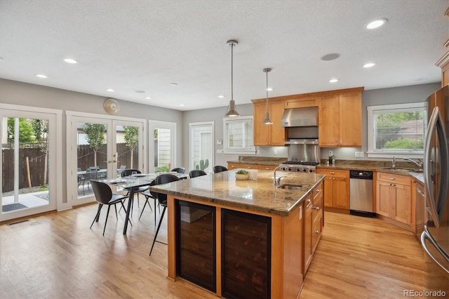 1526 S Gaylord St, Denver, CO 80210 - kitchen featuring wine cooler, wall chimney range hood, a sink, an island with sink, and recessed lighting