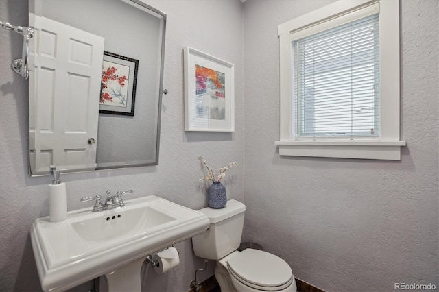 1526 S Gaylord St, Denver, CO 80210 - bathroom with toilet, a sink, and a textured wall