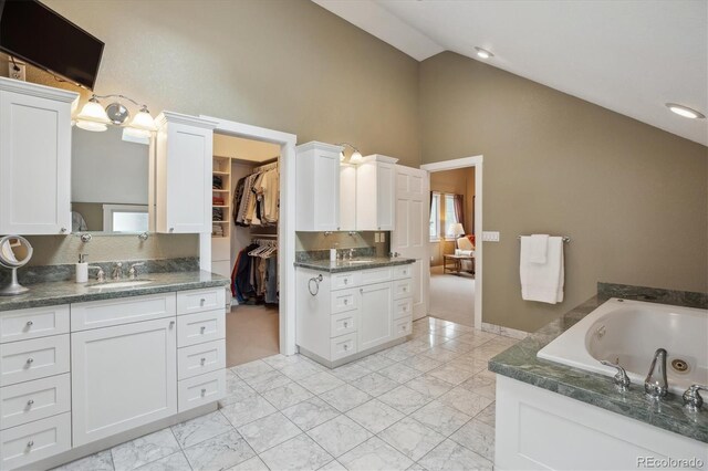 1526 S Gaylord St, Denver, CO 80210 - kitchen with a sink, white cabinets, high vaulted ceiling, and baseboards