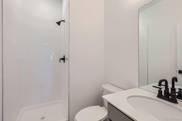 bathroom with toilet, walk in shower, and vanity