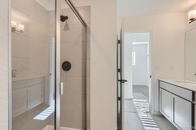 bathroom featuring vanity and a shower with shower door