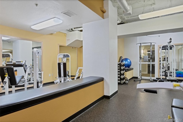 workout area featuring a textured ceiling