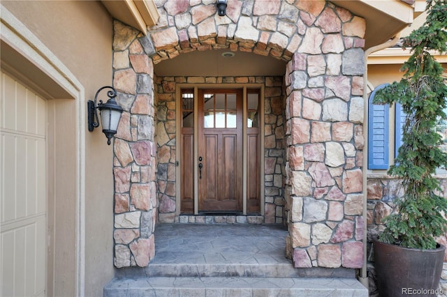 property entrance with stone siding