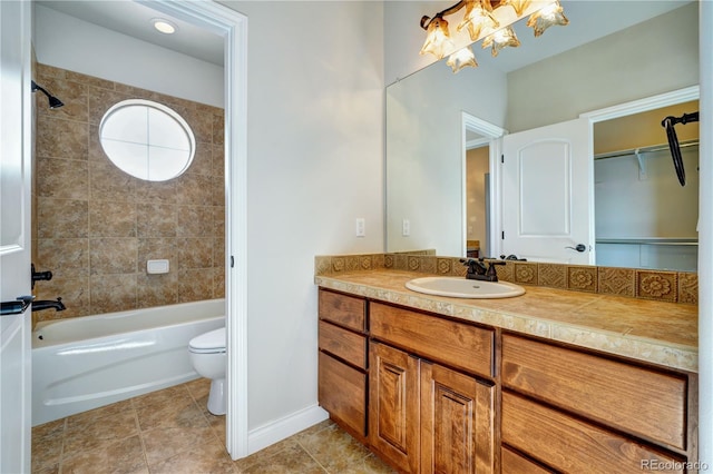 full bath with tile patterned flooring, toilet, vanity, baseboards, and shower / bathing tub combination