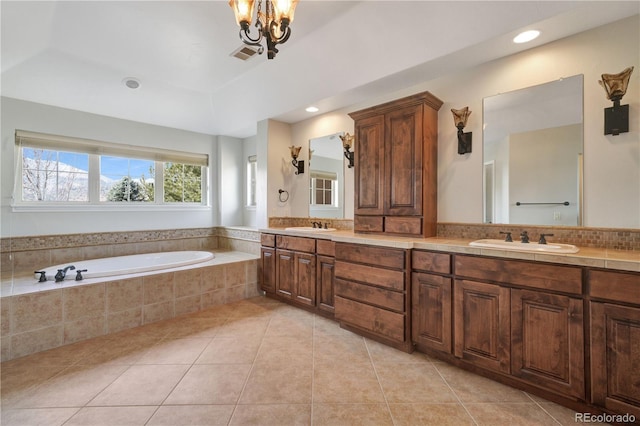 full bath with visible vents, a sink, a bath, and tile patterned floors