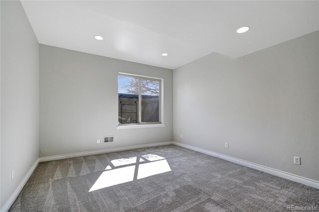 carpeted spare room with recessed lighting, visible vents, and baseboards