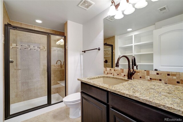 bathroom with toilet, a stall shower, visible vents, and backsplash