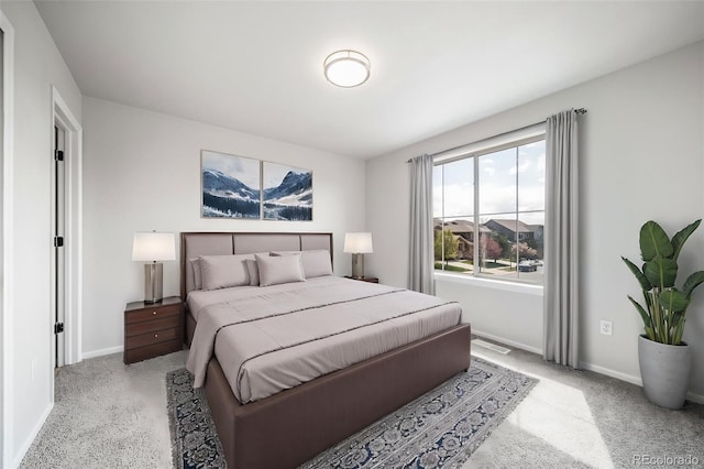 bedroom featuring baseboards and light carpet