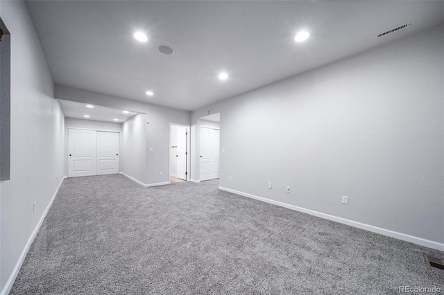 empty room featuring recessed lighting, carpet flooring, and baseboards