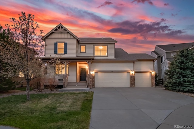 view of front facade featuring a front lawn, an attached garage, stone siding, a porch, and driveway