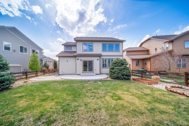rear view of property with a fenced backyard, a patio area, a yard, and a garden