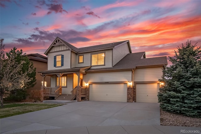 craftsman inspired home with stone siding, a garage, board and batten siding, concrete driveway, and covered porch