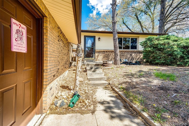 doorway to property with brick siding