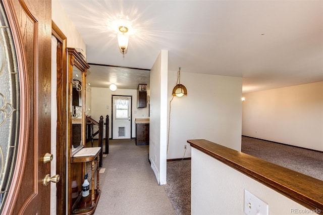 corridor with dark colored carpet and baseboards